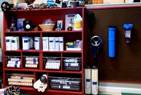 Sediment filter systems and cartridges on display shelving